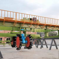 Wheel type compost turner for large scale organic composting
